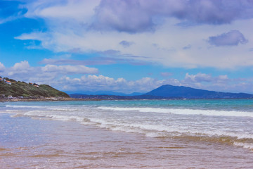 Beautiful landscape with ocean, sea, mountains, blue sky and white clouds