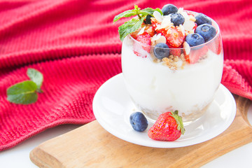 Healthy blueberry, strawberry and walnut parfait in a glass 