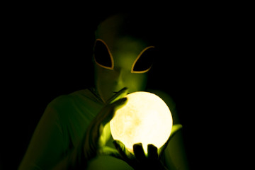 comical alien with glowing orb