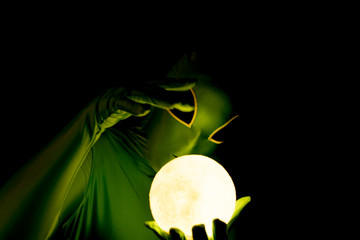 comical alien with glowing orb