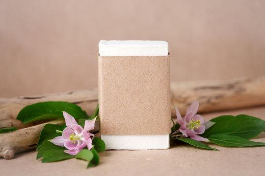 Zero waste natural cosmetics products on craft paper table. Flat lay, organic solid soap and shampoo bars, antibacterial handcrafted soap concept, mock up, organic detail, tropical flowers