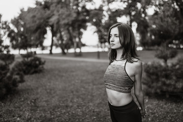 Black-white portrait of a girl in the park. Yoga and fitness