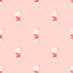 Seamless pattern with Sanitary Pads and confectionery coral heart on pink background, top view, flat lay. Concept of critical days, menstruation, printshop, contemporary monochrome background