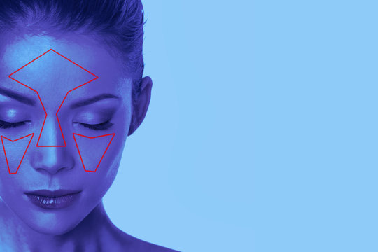 Facial recognition technology beauty woman face scan in blue light.
