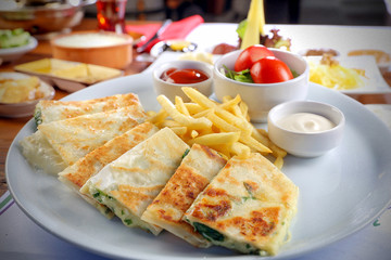 cheese and parsley pancake gözleme on breakfast table