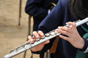 フルートを演奏している若い女性のしなやかな手