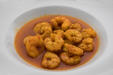 Mediterranean cuisine. Seafood. Closeup of a shrimp scampi dish served in a white plate.	
