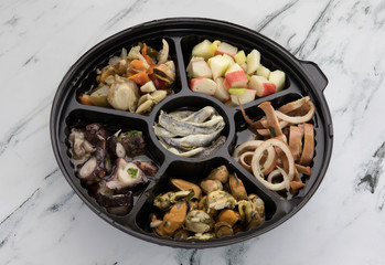 Traditional mediterranean seafood picada dish with a variety of seafood preparations. Squid, mussels and octopus with provencal condiment. Anchovies, scallops and pickles in vinegar. Kanikama salad.
