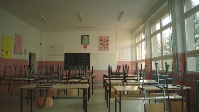 An Empty classroom at school or university with chairs on desks