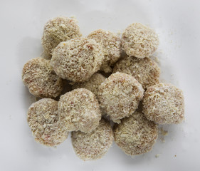 Culinary. Cooking fish recipe. Uncooked pollock fish cheeks breaded into balls, ready for frying. 
