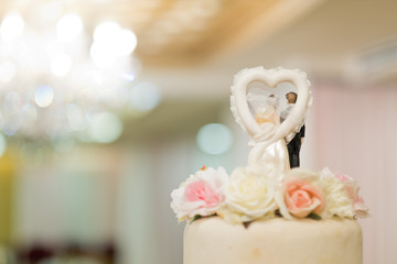 Wedding doll on cake, love couple
