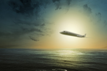 Fototapeta na wymiar Airplane flying in the air above the ocean