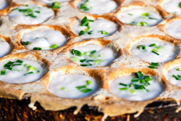 Close -up Ka Nom Kork Traditional Thai dessert , sweetmeat on cooking pan with coconut milk