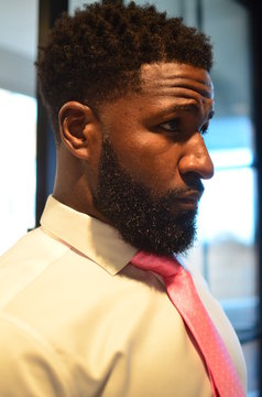 Portrait Of Young African American Man Getting Dressed For The Day