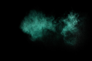 Aquamarine powder explosion on black background. Colored powder cloud. Colorful dust explode. Paint  Holi.
