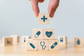 Hand arranging wood block stacking with icon healthcare medical, Insurance for your health concept