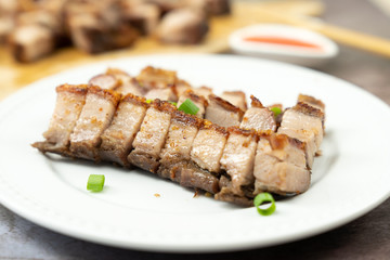 Oriental roast pork belly or char siew on white plate