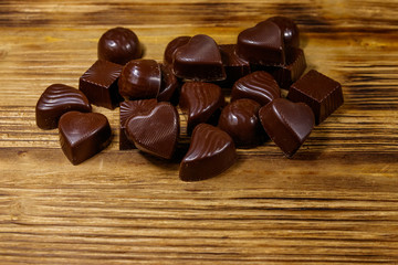 Tasty chocolate candies on wooden table
