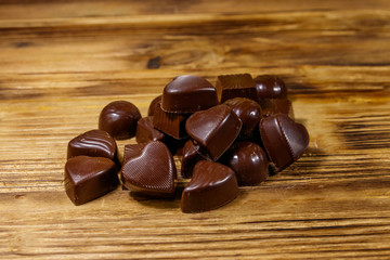 Tasty chocolate candies on wooden table