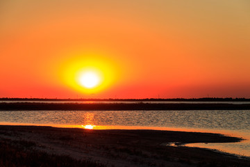 Beautiful orange sunset over a salt lake