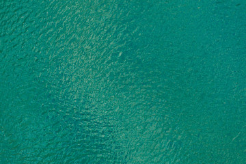 Fototapeta na wymiar Aerial view texture of turquoise sea with ripples