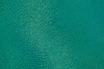 Aerial view texture of turquoise sea with ripples