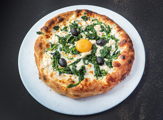 pizza on the black background, top view