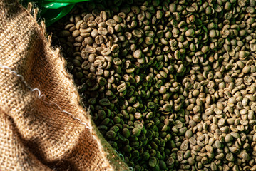 Green coffee bean raw in sack with scoop