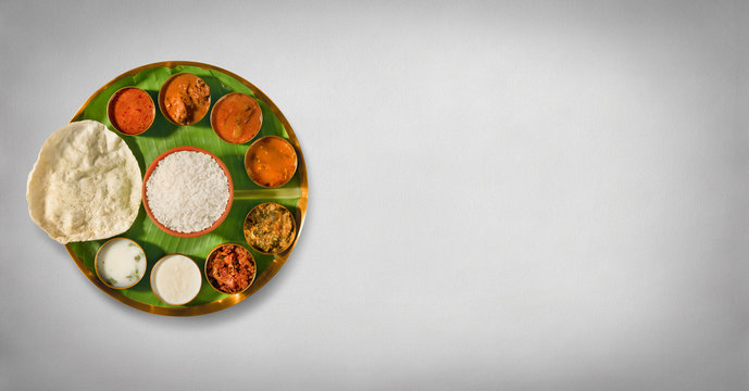 south india meals, meals served on banana leaf brass plate , traditional south indian cuisine, rice, sambar, rasma, appalam, white rice, curd, buttermilk