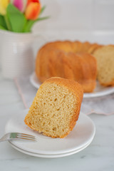 Fresh vanilla bundt cake on a wooden cutting board