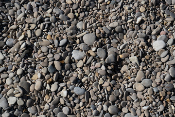 Large pebbles on a frame by the sea. Texture for the background.