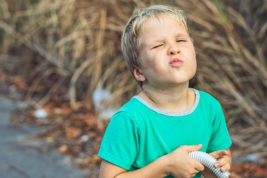 Funny Mischievous Cute Blond Boy Making Freckles Face Showing Love Kiss, Artistic Emotions Gesturing. Behaviour Education, Micro Moments Joys Of Happy Childhood, Compassion Toward Humanity And Society