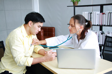 Fototapeta premium Young Caucasian Female psychiatrist is specialist in psychiatry is Maintaining with Stethoscope on back of asian male Patient with depression in Clinical treatment for emotional symptoms.