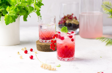 Fresh, cold lemonade with berries, lemon and mint in a glass on a light background. summer, vacation, holidays, sea concept 