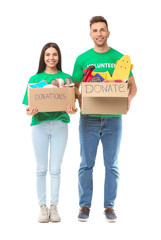 Volunteers with donations for orphans on white background