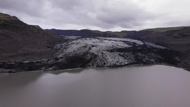 Aerial images flying over a glacier and its glacier lagoon (high altitude)