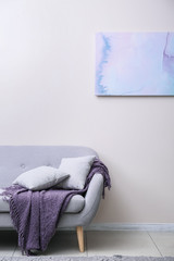 Soft couch near light wall in room