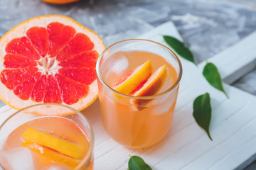 Glasses of fresh grapefruit juice on table