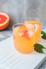 Glasses of fresh grapefruit juice on table