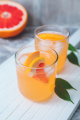 Fototapeta premium Refreshing Grapefruit Drinks with Ice and Citrus Slices