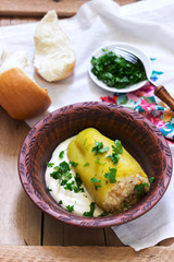 Stuffed peppers served with sour cream and bread, a traditional dish of different nations.