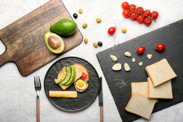 Tasty avocado sandwiches on light background