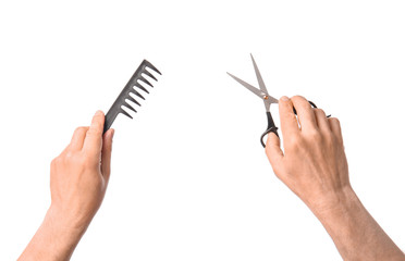 Male hands with hairdresser's tools on white background