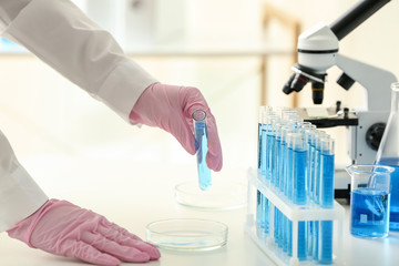 Scientist working with sample in laboratory