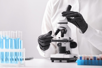 Scientist using microscope in laboratory