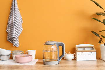 Electric kettle and tableware on kitchen table
