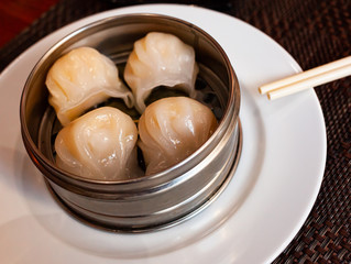 Japanese style boiled gyoza dumplings stuffed with minced pork served with soy tare sauce