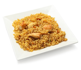 Plate with tasty pilaf on white background