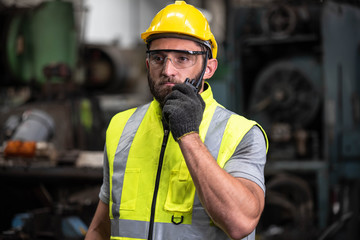 Portrait of technician man or industrial worker with hardhat or helmet, eye protection glasses,...