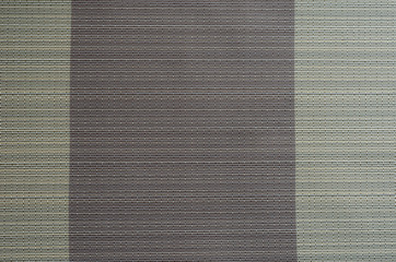 Abstract background from intertwined beige and purple threads.